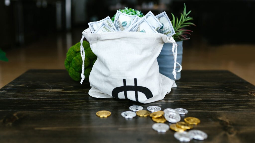 Bag of money and crypto coins on a table