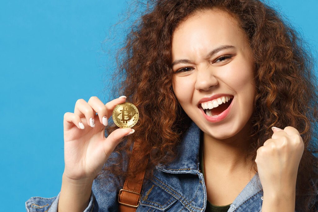 Happy woman holding bitcoin